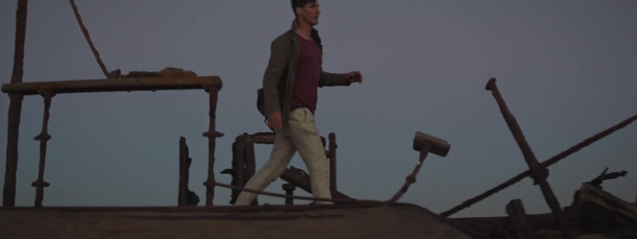 Young man explores rusted shipwreck