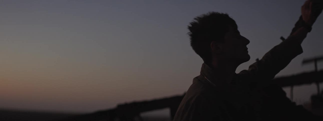 A man watching the sunset on a shipwreck