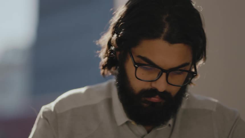 Bearded man working on a tablet