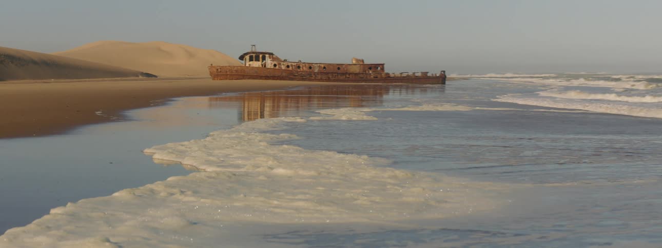 A rusted out shipwreck on the beach