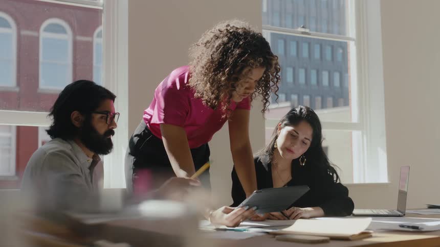 Confident black woman leads a business meeting with coworkers