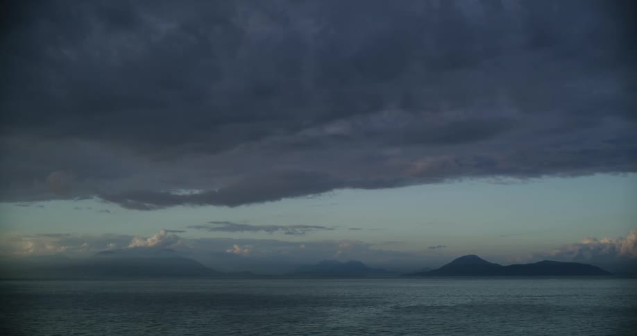 Dark gray storm clouds hang over coastal waters