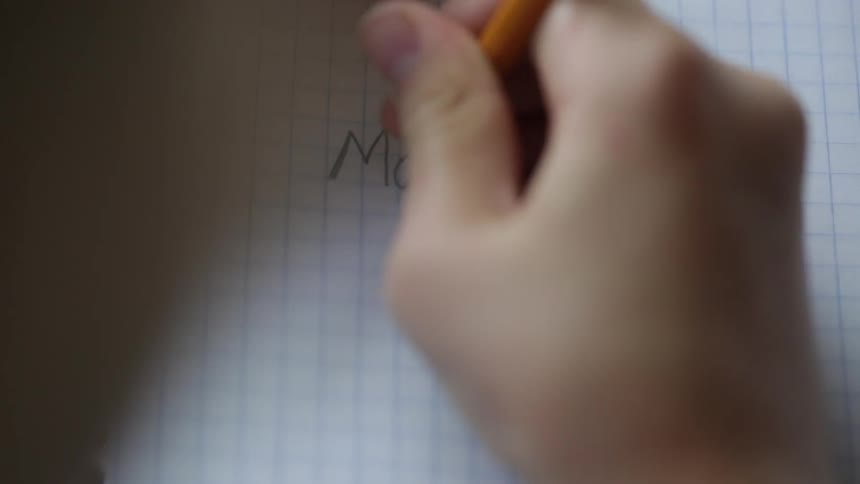 A hand writing on paper