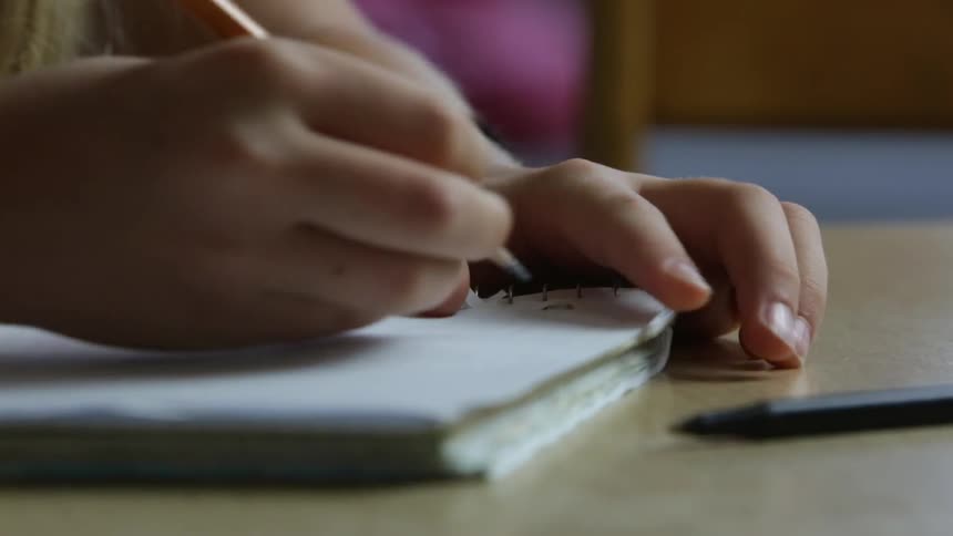 A girl writing in a notebook