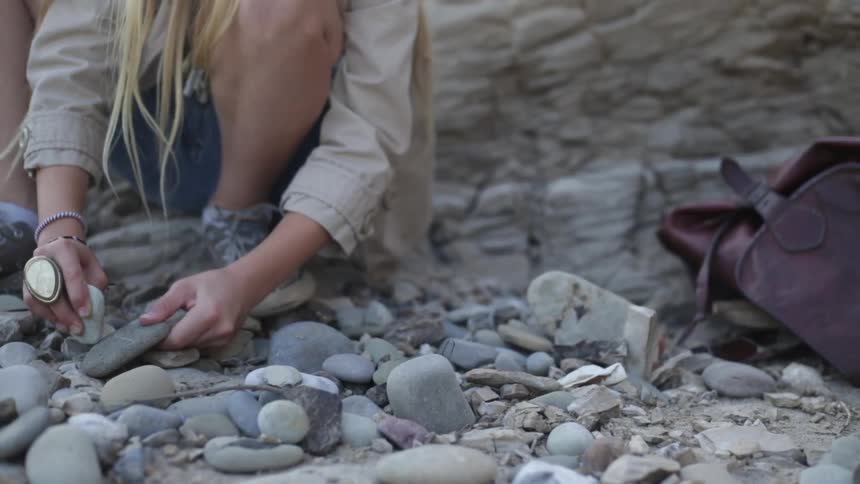A girl is sorting rocks