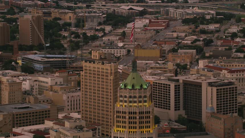 The american flag flies high above the tower life building in san antonio