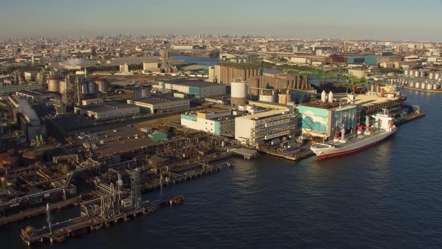 Aerial view of a city near the ocean coast is displayed