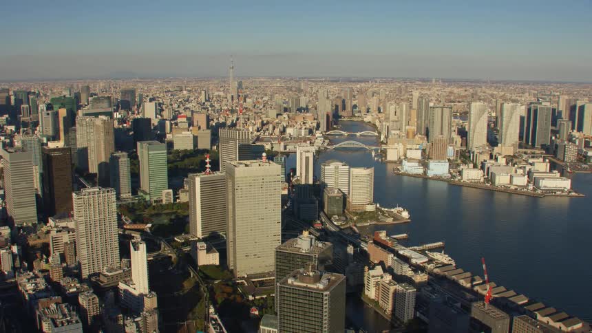 An aerial view of high rise office buildings in a city with a river running through it