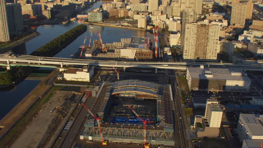 Cars travel on the overpass past the city