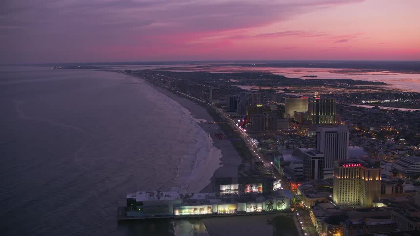 An aerial view of hotels along the shore at dusk