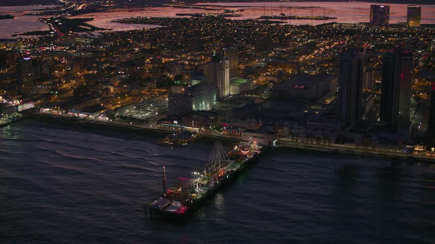 Aerial view of a city during sunset is displayed