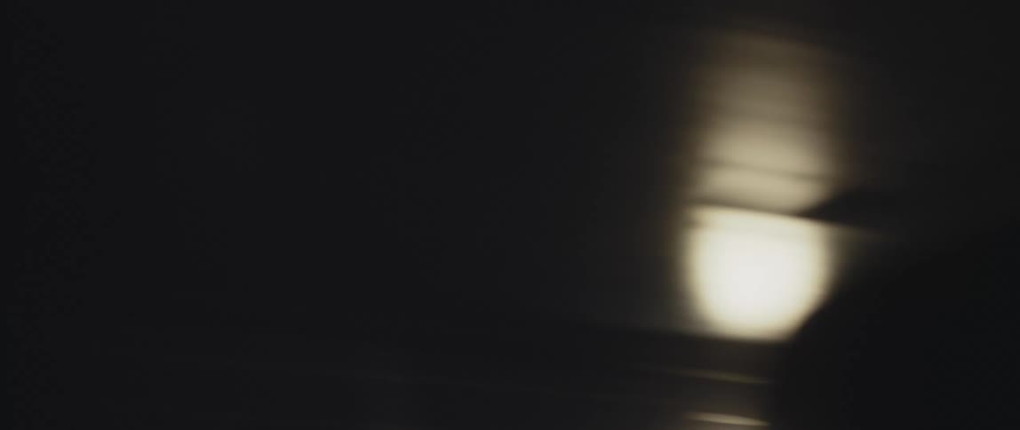 Several stationary lights on a wall are passed with great velocity