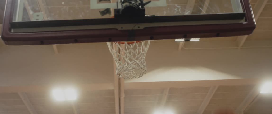 Multiple basketballs are shot into the net