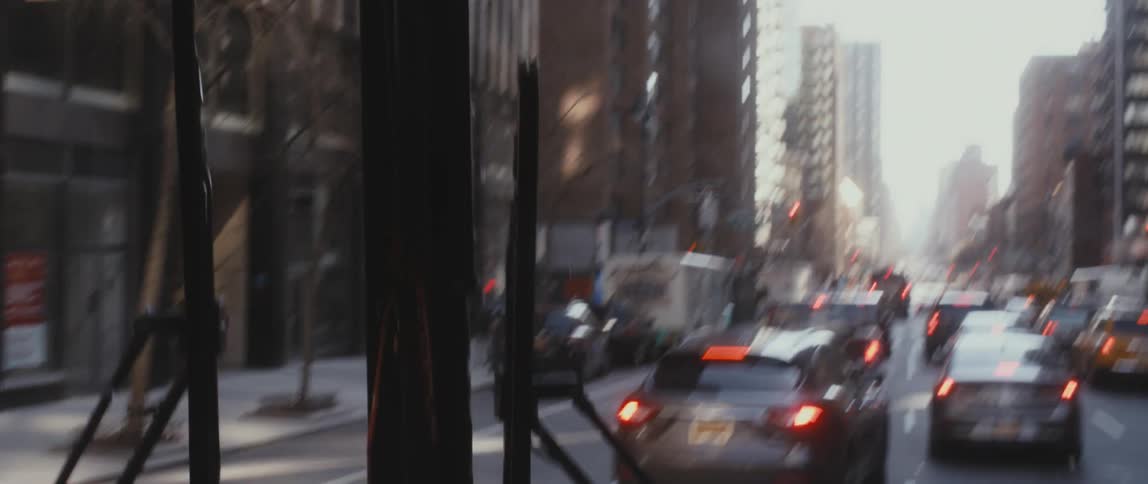 A view of a bus driving in a city