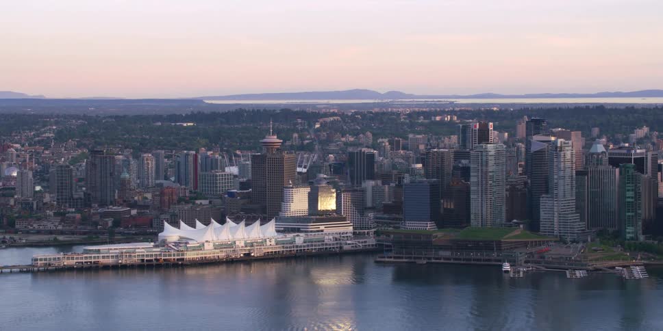Aerial view of a downtown city near the coast is displayed