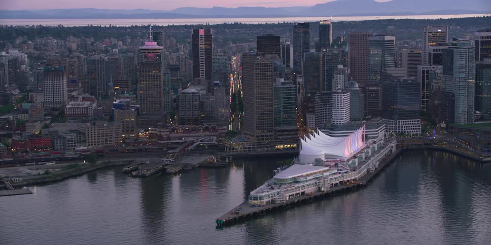 Aerial view of a downtown city during dusk is displayed
