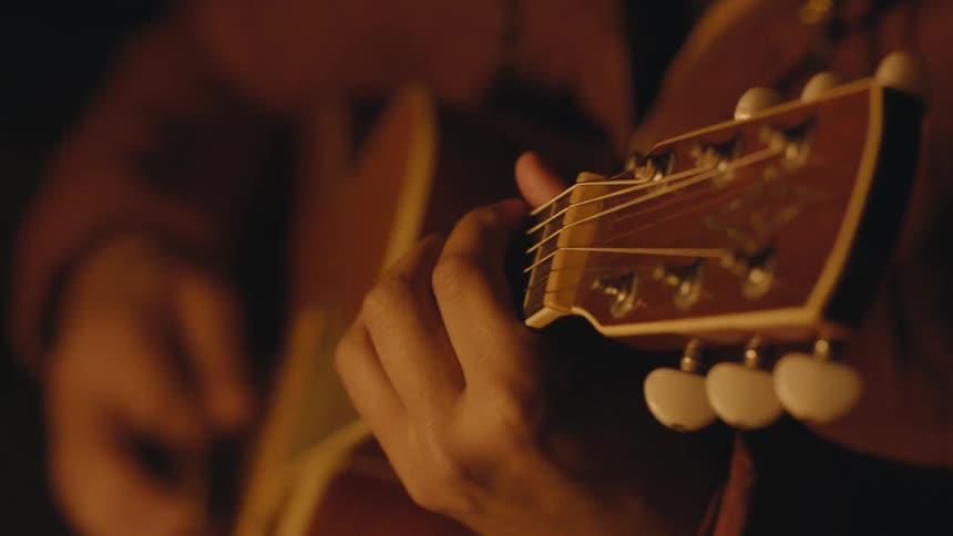 Someone playing an acoustic guitar