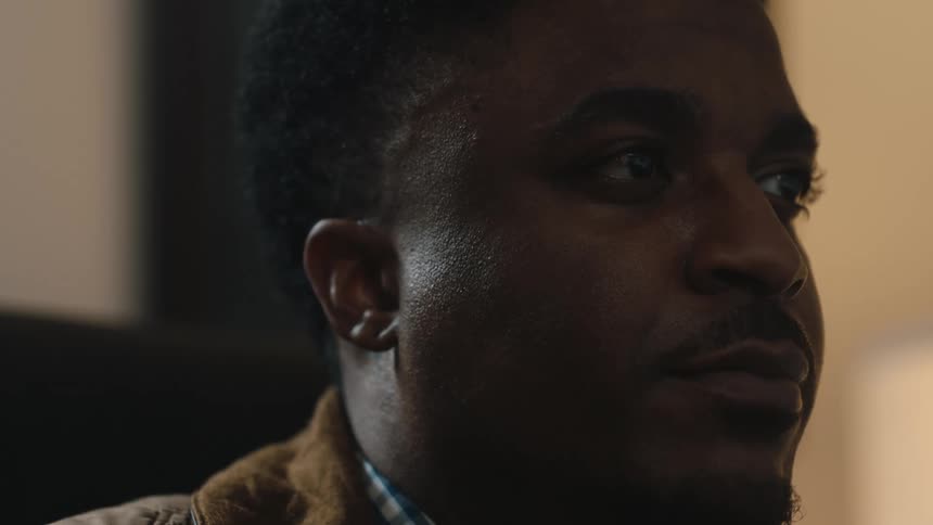 A man looks around and talks