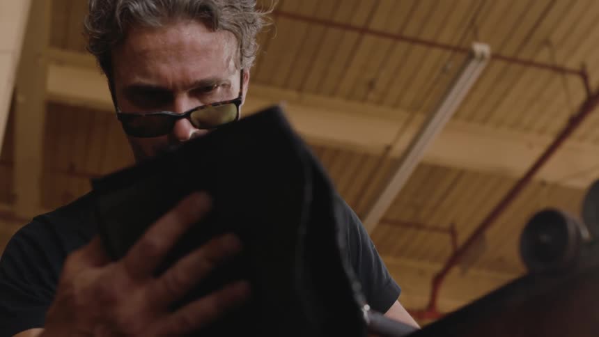 A glass blower shaping a new piece