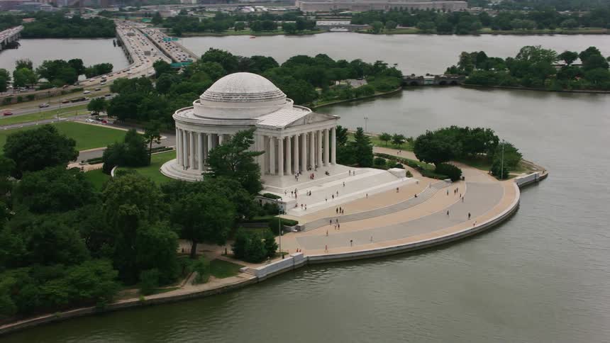 Tourists walk on the grounds of the jefferson memorial in washington dc