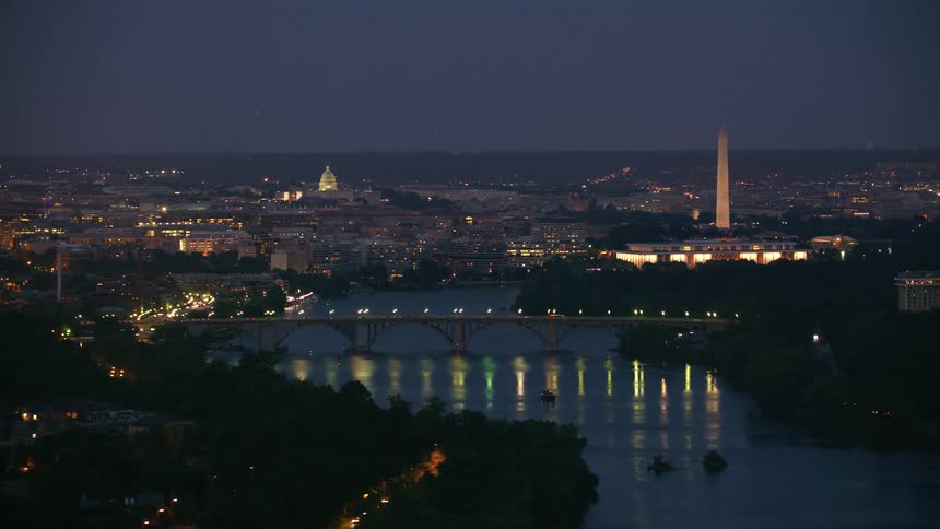 Aerial view of city skyline at night is displayed