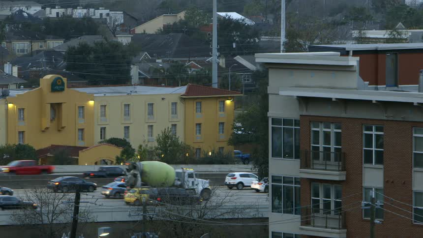 Vehicles travel on a busy road in a city