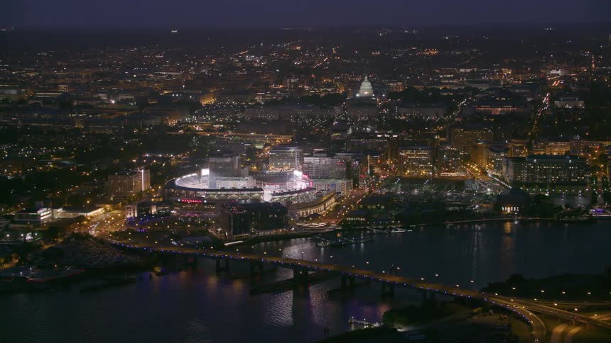 Aerial of a downtown city at night is displayed