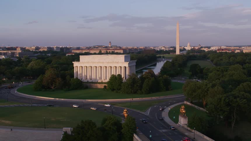 An aerial view of government buildings and landmarks in a city with cars driving on streets