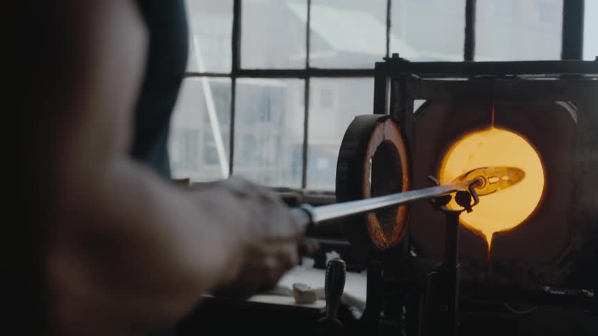 A person is twisting a tool in a flame machine