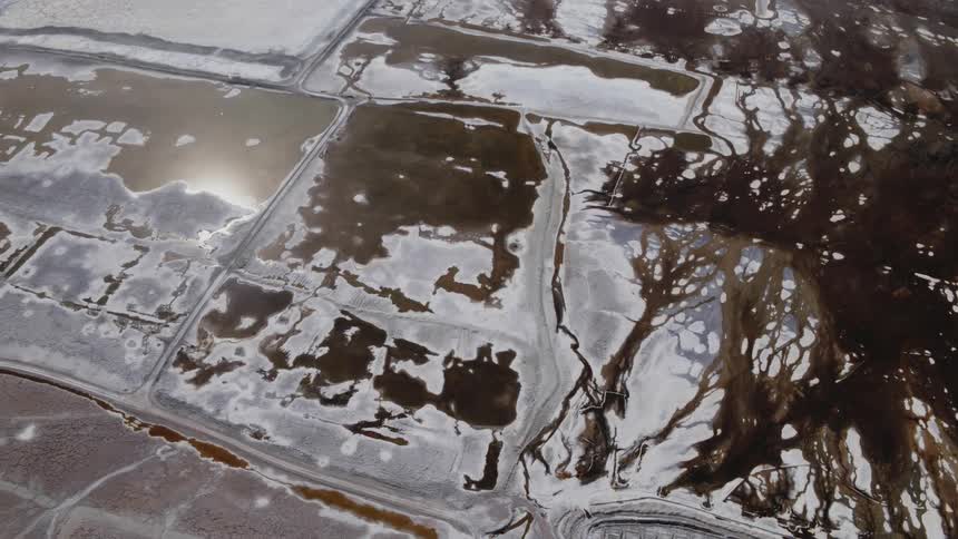 Aerial view of a drying lakebed with a chemical oil spill