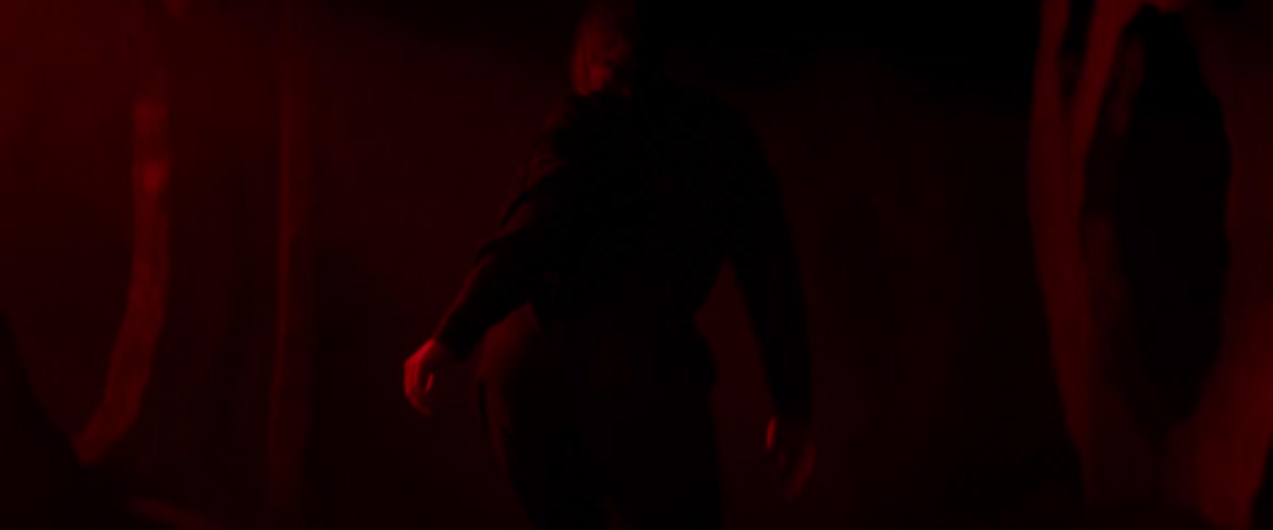 A woman is dancing in a dark lit room