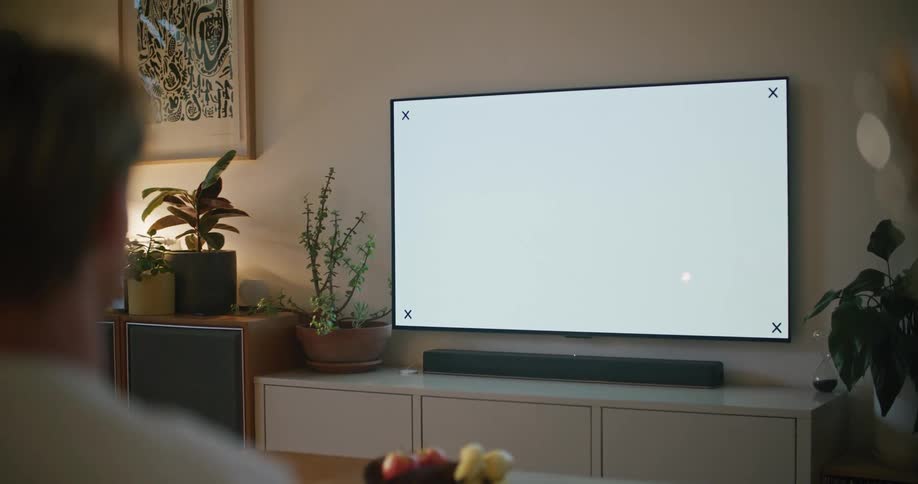 Man is watching television in his living room