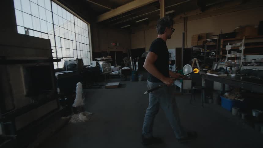 A glass blower working on a new piece