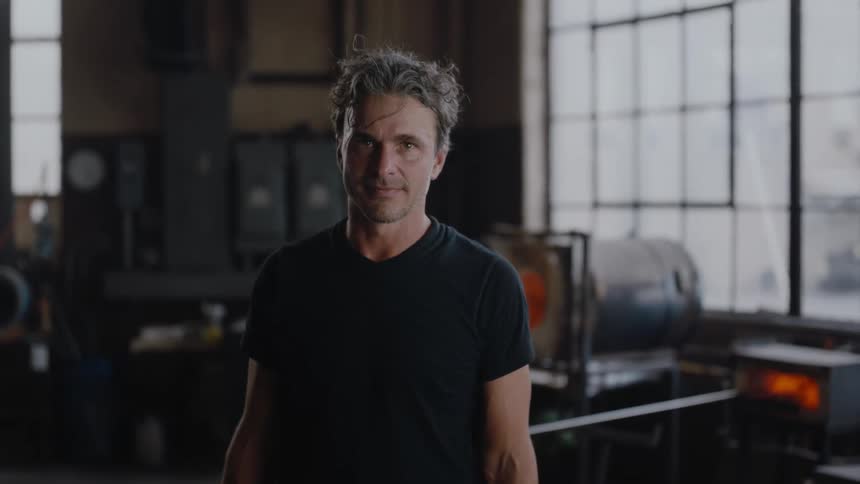 A man is standing in his artisan studio