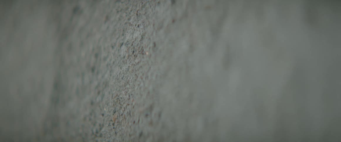 Close up of the rugged textured surface of a granite wall