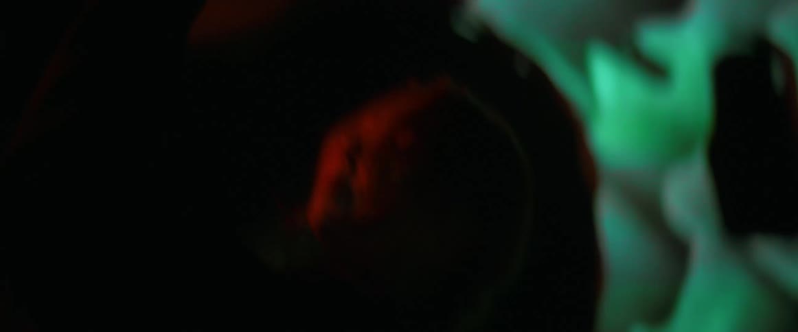 A woman is dancing in the dark