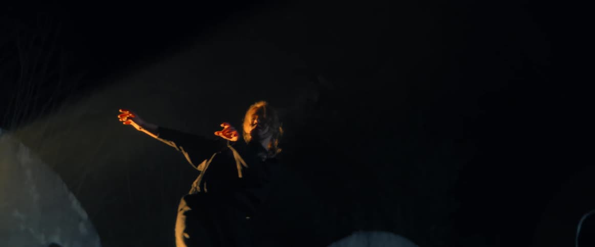 A woman is dancing at night