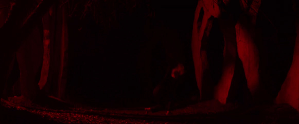 A woman is dancing in the dark