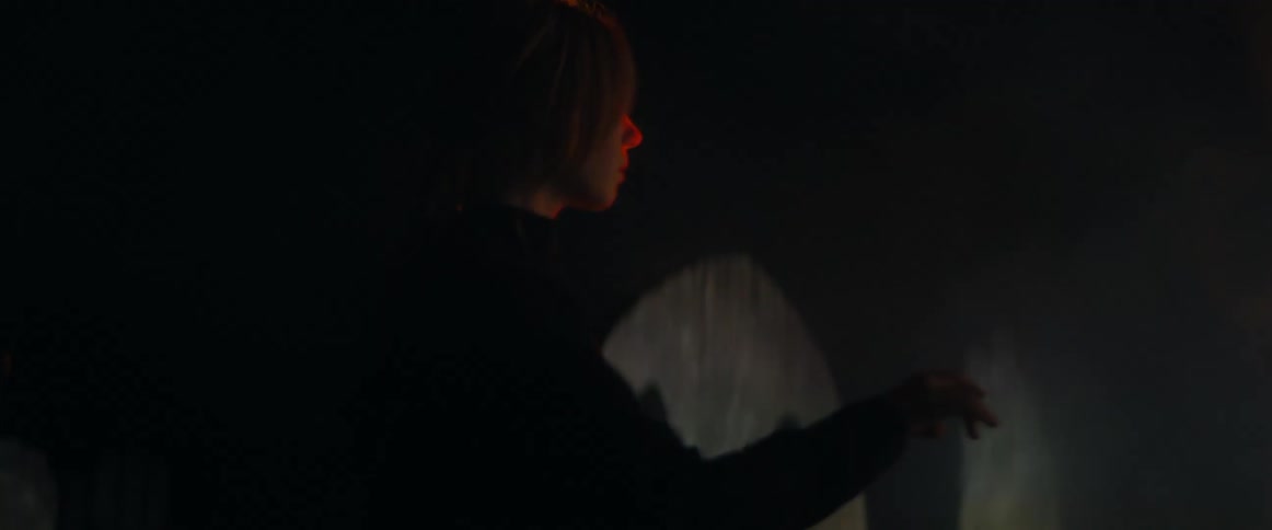 A woman is walking outdoors during the night time