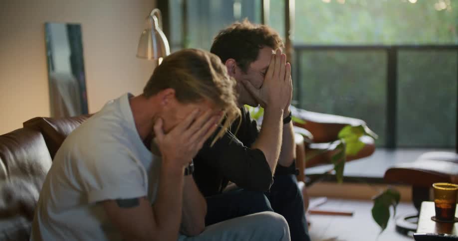 Two men get angry at something they are watching