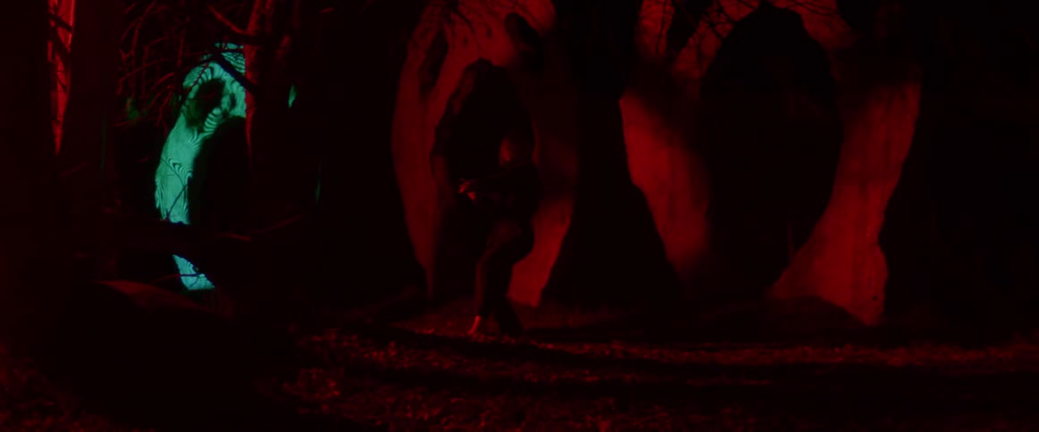 A woman is dancing in the dark