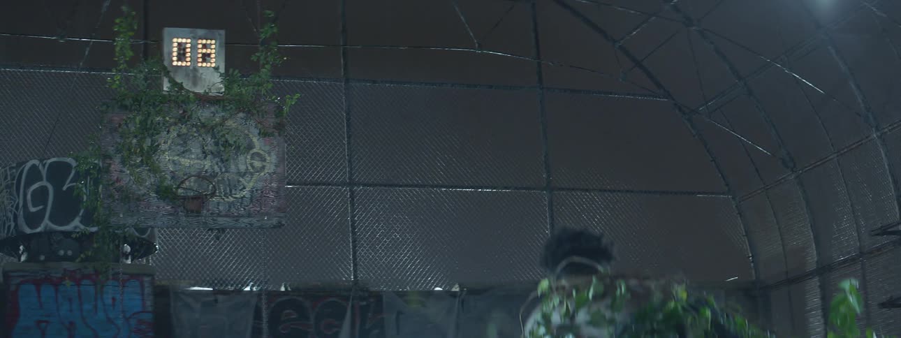 A shot clock is counting down as a man is crouched below