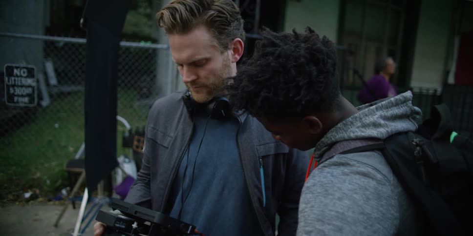 A man is showing his camera to someone