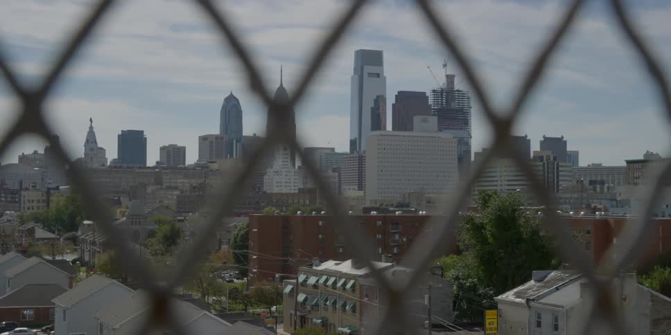 View of a city from behind a fence
