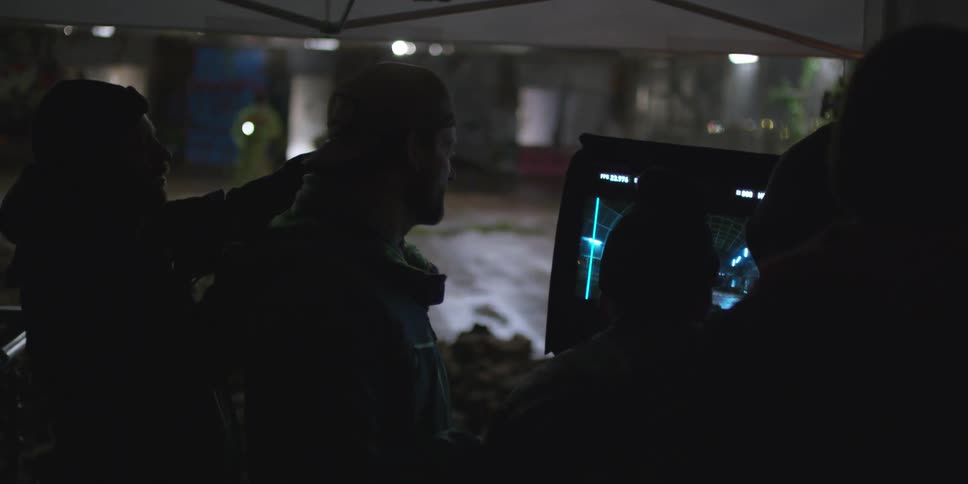 People are standing around a display in a dark area