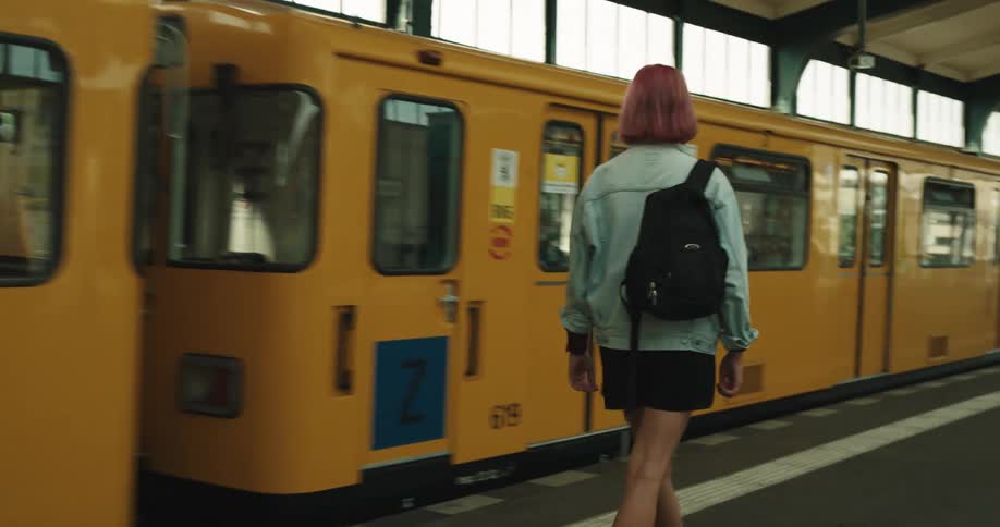 A woman gets on the train