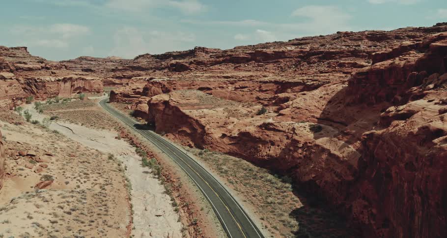 A road through a canyon in the badlands during the day