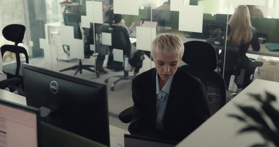 Tired nervous woman sitting at a desk working at the office