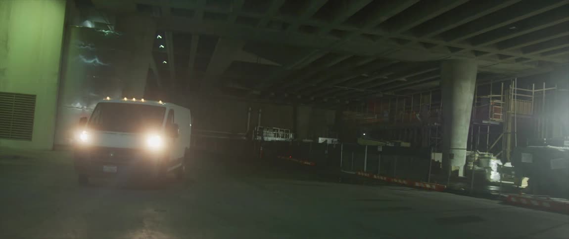 Driver pulls van away from storage area under structure
