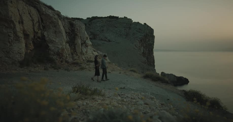 A couple walk towards the beach